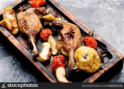 Appetizing roasted duck leg with apples and vegetables.Duck meat. Duck legs with vegetable garnish