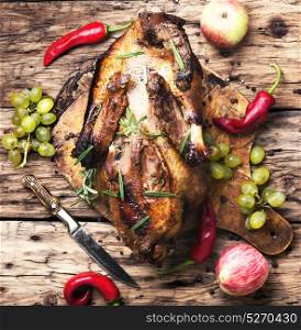 Appetizing roasted duck. roasted duck with apples on the kitchen cutting board