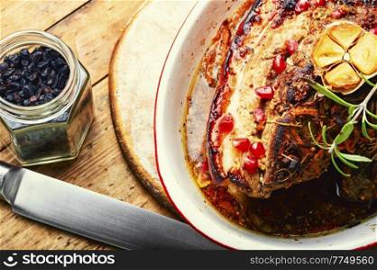 Appetizing roasted meat with herbs and spices.. Pork belly in spices.