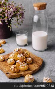 Appetizing ruddy buns-roses and milk bottle