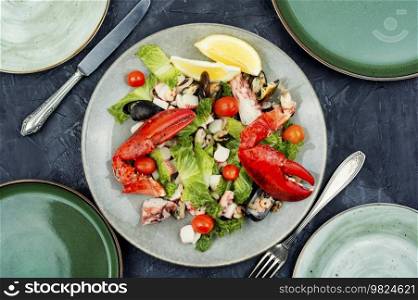 Appetizing salad of oysters, mussels, lobster and vegetables. Ketogenic. Italian mixed seafood salad