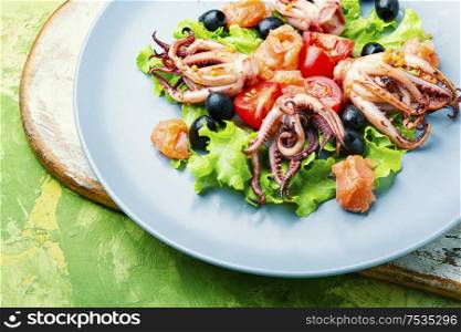 Appetizing salad with calamari, salmon and vegetables.Thai food. Salad with squid