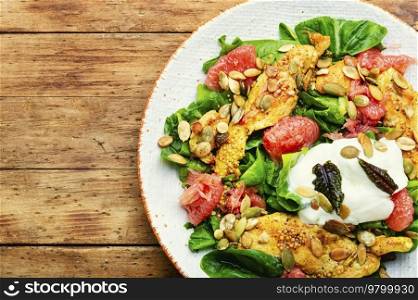 Appetizing salad with chicken meat, greens and citrus fruits. Ketogenic diet.. Fresh salad with chicken breast, herbs and grapefruit