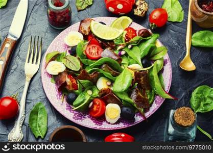 Appetizing salad with fresh herbs, raw vegetables and bacon. Healthy vegetable and bacon salad