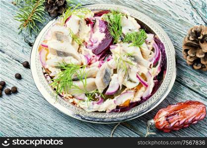 Appetizing salad with herring and vegetables.Russian cuisine.Traditional Ukraine salad herring under fur coat. Christmas salad with herring