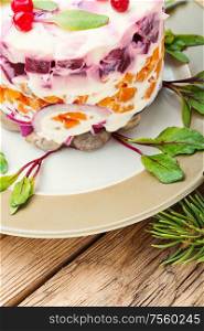 Appetizing salad with herring and vegetables.Seafood salad.Traditional Ukrainian salad.Russian cuisine.. Christmas salad with herring