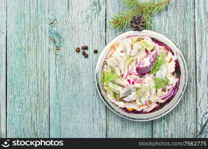 Appetizing salad with herring and vegetables.Seafood salad.Traditional Ukrainian salad.Russian cuisine.Space for text. Christmas salad with herring