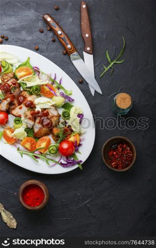 Appetizing salad with tomato,cucumber,lettuce and meat steak.Sliced grilled steak. Meat salad with fresh vegetables.