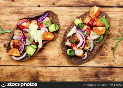 Appetizing sandwiches or bruschetta made from vegetables and meat. Homemade taco or bruschetta
