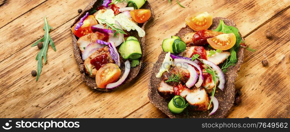 Appetizing sandwiches or bruschetta made from vegetables and meat. Homemade taco or bruschetta