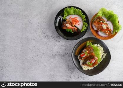Appetizing Spicy Canned Sardine in spicy sauce in black ceramic bowl