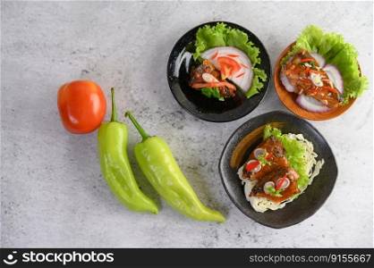 Appetizing Spicy Canned Sardine in spicy sauce in black ceramic bowl