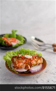 Appetizing Spicy Canned Sardine salad with spicy sauce in wood bowl
