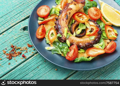 Appetizing spring or summer salad with vegetables and octopus.. Healthy octopus salad