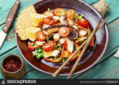 Appetizing spring or summer salad with vegetables and octopus.. Healthy octopus salad
