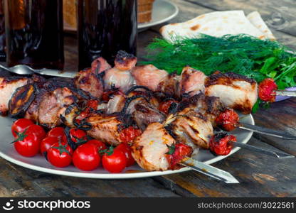 appetizing tasty shish kebab with vegetables on skewers close-up