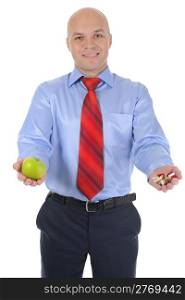 Apple and pills in the hands of a businessman. Isolated on white background