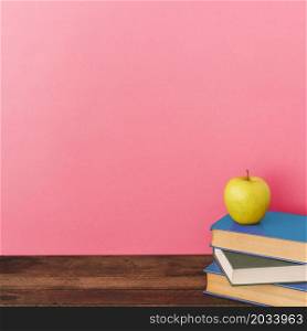 apple books near pink wall