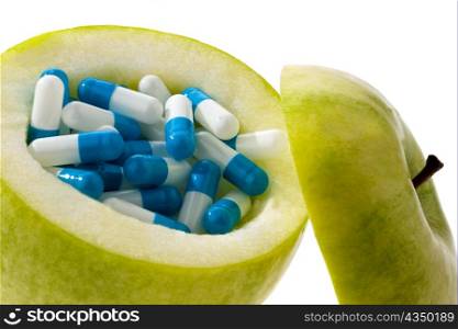 apple capsules with tablets. symbolic photo for vitamin tablets