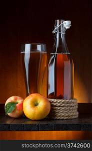 apple cider glass and bottle with apples still life
