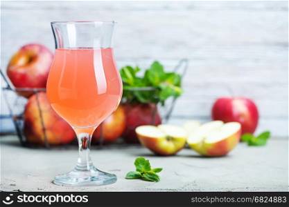 apple cider in glass and on a table