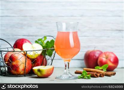 apple cider in glass and on a table