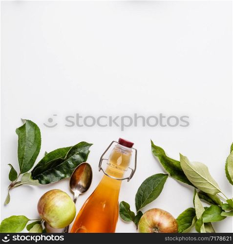 Apple cider vinegar and fresh apples, flat lay, space for your text. Fermented food concept. Apple cider vinegar and fresh apples, flat lay, space for your text
