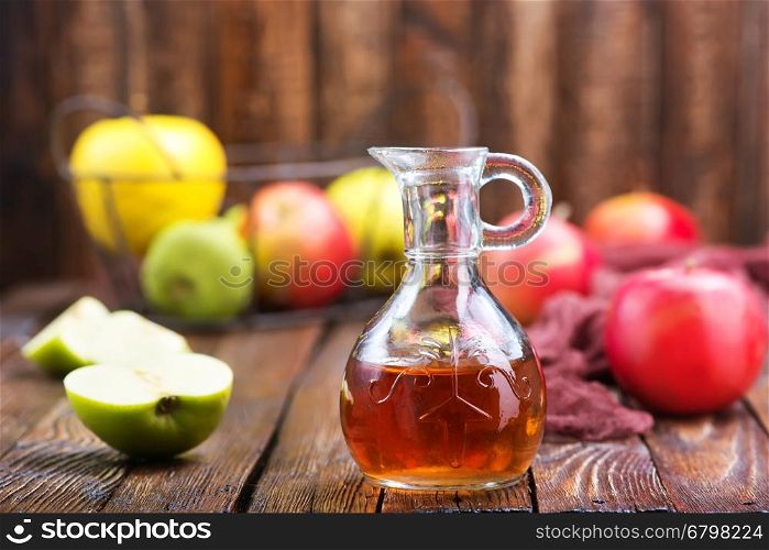 Apple cider vinegar in bottle and on a table
