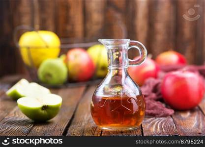 Apple cider vinegar in bottle and on a table