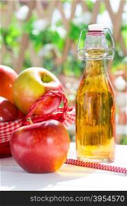 Apple cider vinegar with a fresh apple