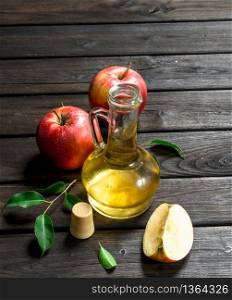Apple cider vinegar with fresh apples. On wooden background.. Apple cider vinegar with fresh apples.