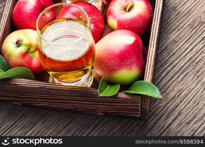 Apple cider with fresh apples on rustic background.Refreshing apple cider. Apple cider cocktail