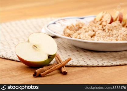 Apple Cinnamon Porridge - shallow depth of field with focus on the apple and cinnamon stick