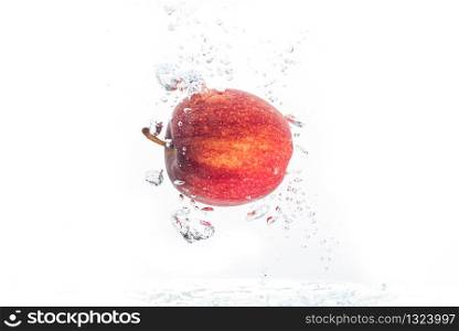 Apple falls under water with a splash.