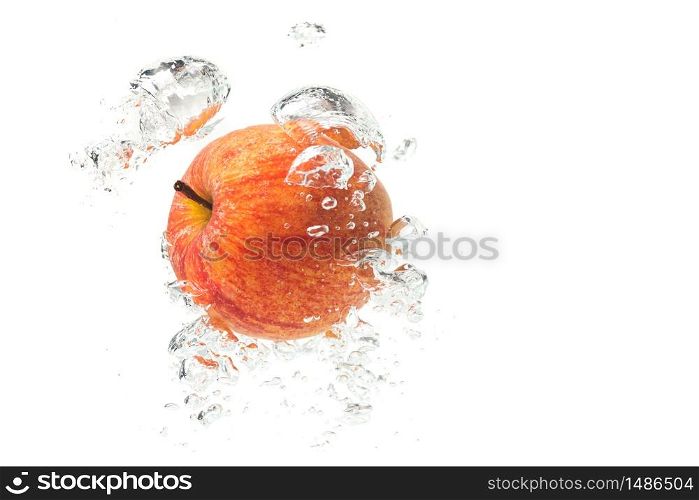 Apple falls under water with a splash. With lots of air bubbles. Product photo. Apple falls under water with a splash. With lots of air bubbles