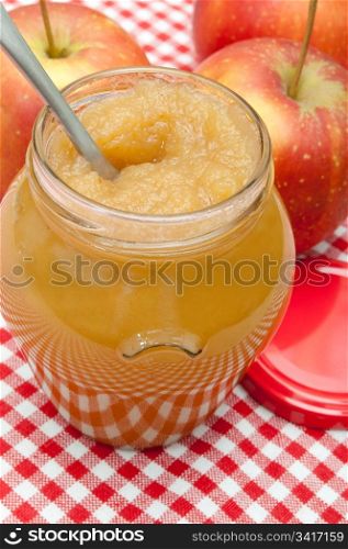 Apple Jam in Jar and Apples on Red Gingham Tablecloth