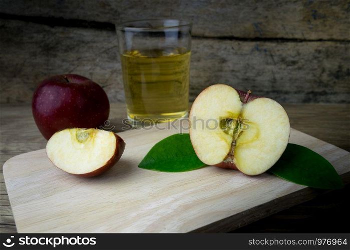 Apple juice and apples on a wooden table