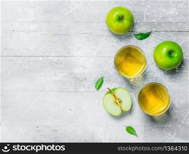Apple juice in a glass Cup with fresh apples. On rustic background.. Apple juice in a glass Cup with fresh apples.
