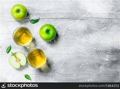 Apple juice in a glass Cup with fresh apples. On rustic background.. Apple juice in a glass Cup with fresh apples.