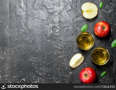 Apple juice in a glass jar with fresh apples in a box. On a dark rustic background.. Apple juice in a glass jar with fresh apples in a box.