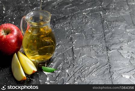 Apple juice in a glass jar with red fresh apples. On rustic background.. Apple juice in a glass jar with red fresh apples.
