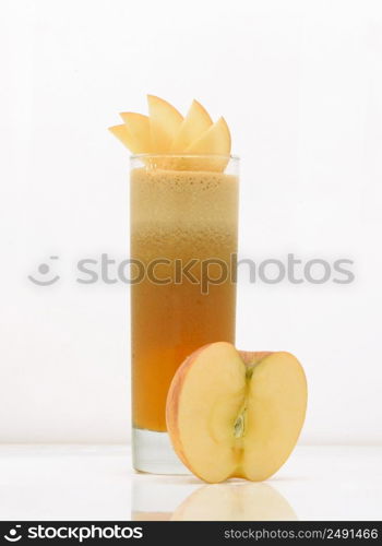 apple juice in a glass with ice and half apple. drink isolated on white background. fruit drinks in a glass