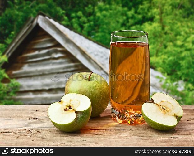 apple juice on a wooden table in the garden