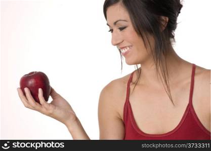 Apple Lover Woman Looks at Fresh Fruit Snack Food. Beautiful Brunette with RED Apple