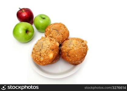 Apple Muffin. Fruit muffins on a white plate with red and green apples on the side