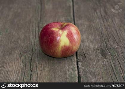 apple on an old wooden table, a subject fruit