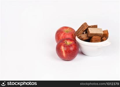 Apple pastila isolated on white background. Healthy snack concept. Pastila in a white bowl and red apple isolated.. Apple pastila isolated on white background. Healthy snack concept.