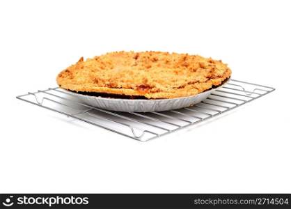 Apple Pie Cooling. Fresh apple pie cooling on a metal wire rack on a light colored background