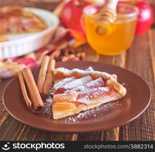 apple pie on plate and on a table