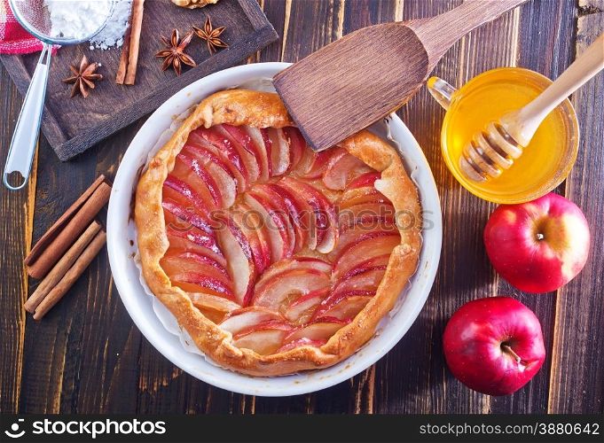 apple pie with honey and cinnamon on a table